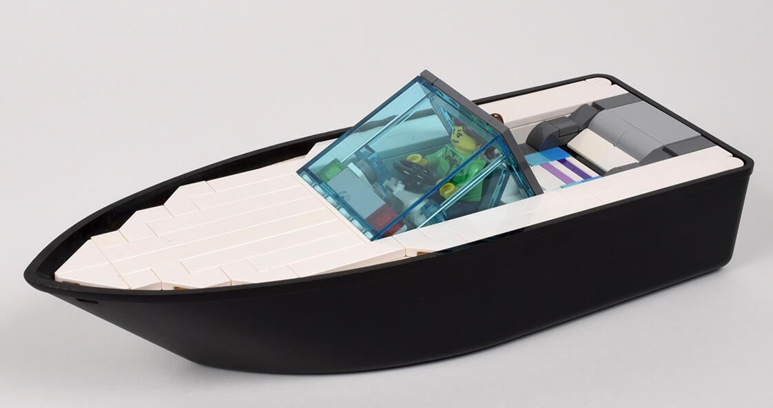 Modern Speedboat - Built on the hull of set 4010: Police Rescue Boat, this model tries to capture the minimalist design of modern speedboats, complete with cupholders and a weighted brick (73090b) under the lounge area so that it sits nicely in the water.